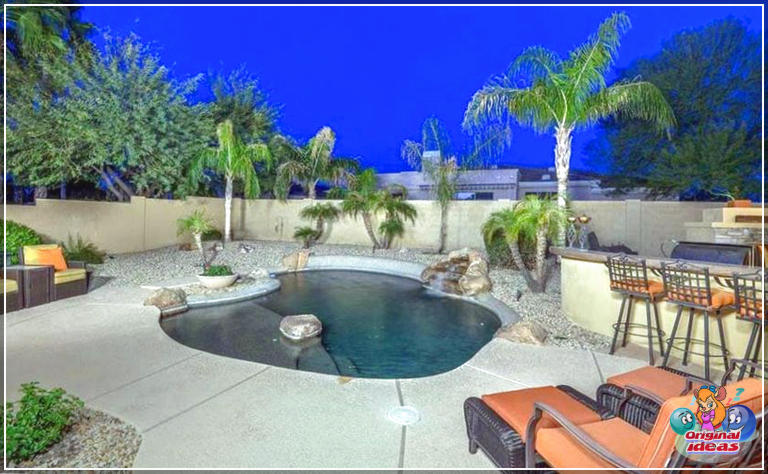 natation Piscine Oasis avec îlots rocheux à côté de la cuisine extérieure et aménagement paysager tropical
