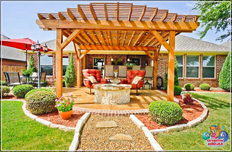 Pérgola para fogatas en el patio trasero con luces colgantes